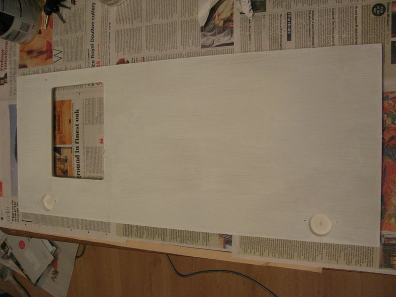 The replacement cupboard door, drilled and primed
