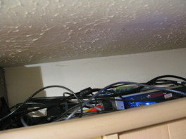 The computer on top of the cupboard